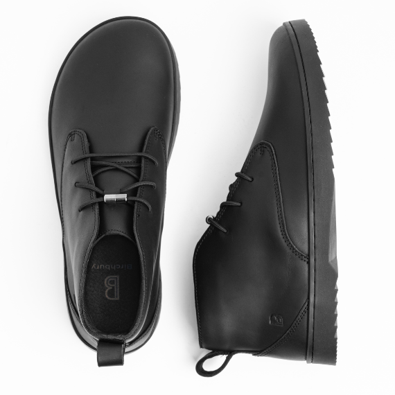 Top-down and side profile views of black rugged leather Birchbury minimalist chukka boots on a white background.