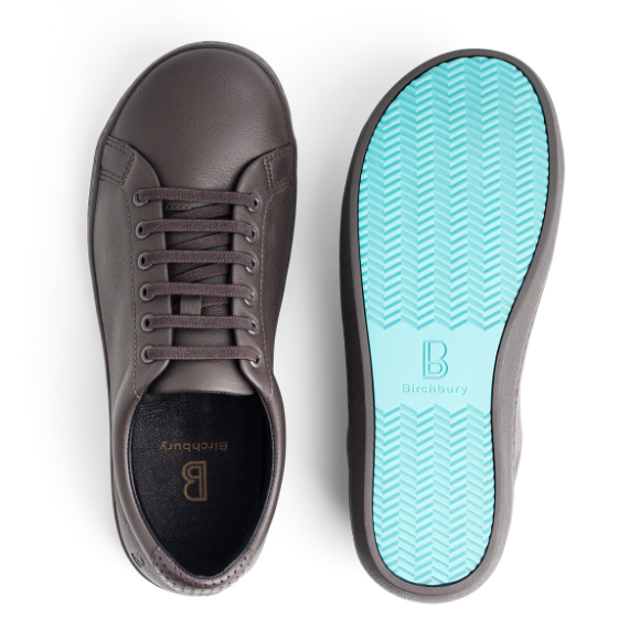 Birchbury brown leather sneaker shown beside its teal rubber sole