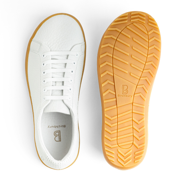Birchbury white leather sneaker shown beside its gum rubber outsole