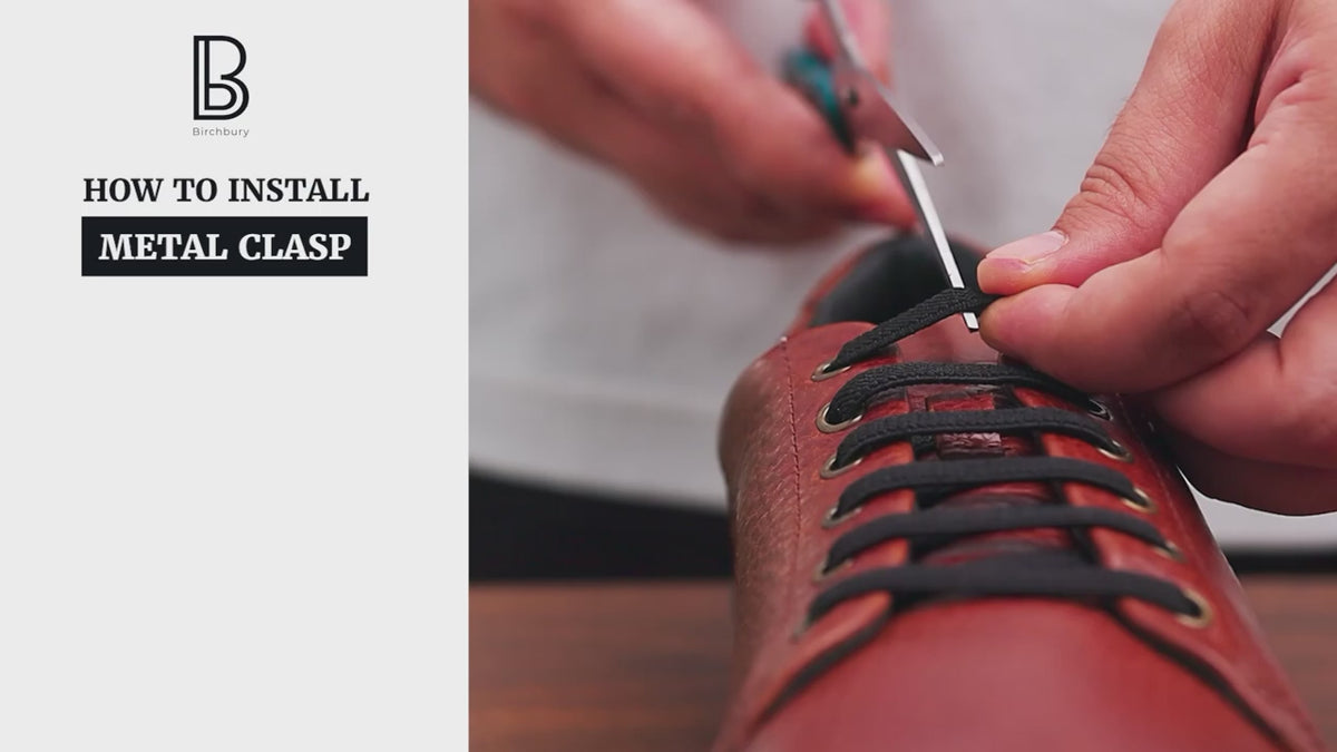Load video: A close-up video tutorial demonstrating how to install a metal clasp on a brown leather Bramford shoe, showing hands cutting the black laces, inserting the ends into the two-piece dark metal clasp, and securing it. On-screen text lists the three installation steps.
