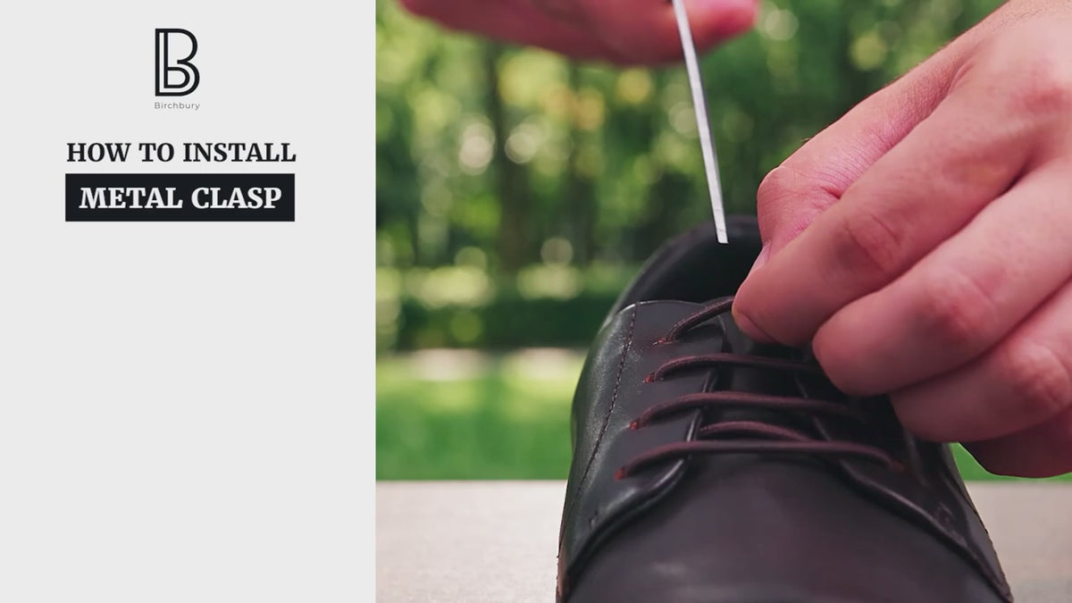 Load video: A close-up video tutorial demonstrating how to install a metal clasp on a maroon leather Brenston shoe, showing hands cutting the black laces, inserting the ends into the two-piece dark metal clasp, and securing it. On-screen text lists the three installation steps.